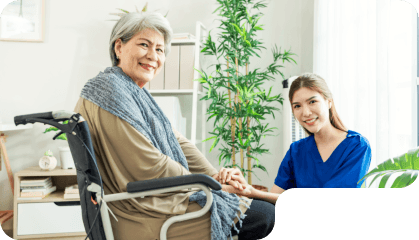 aide and senior woman smiling