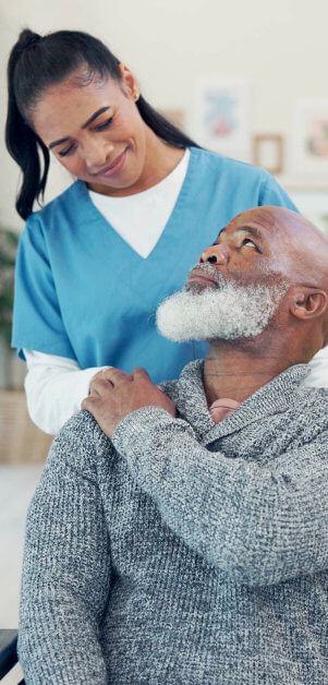 aide and senior man looking at each other
