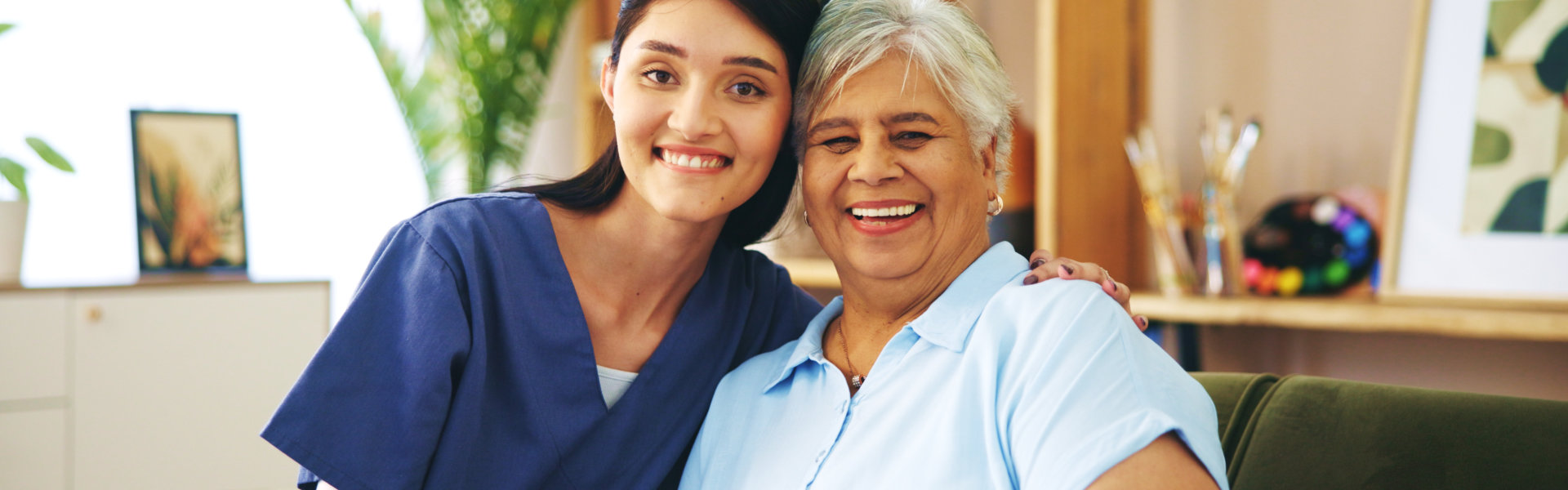 aide and senior woman smiling