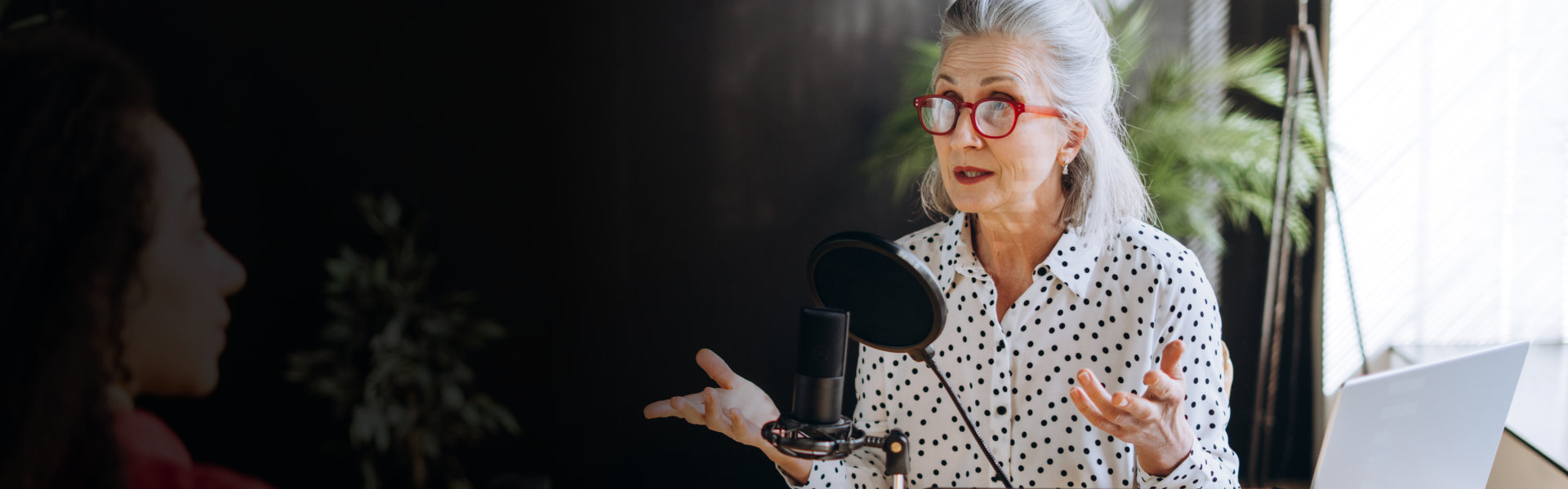 Two person talking in a Podcast setup