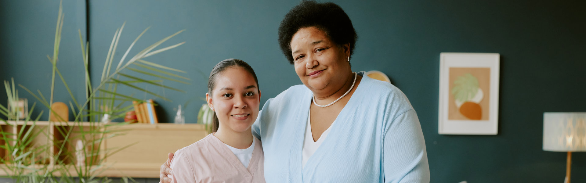 aide and senior woman having a photo together