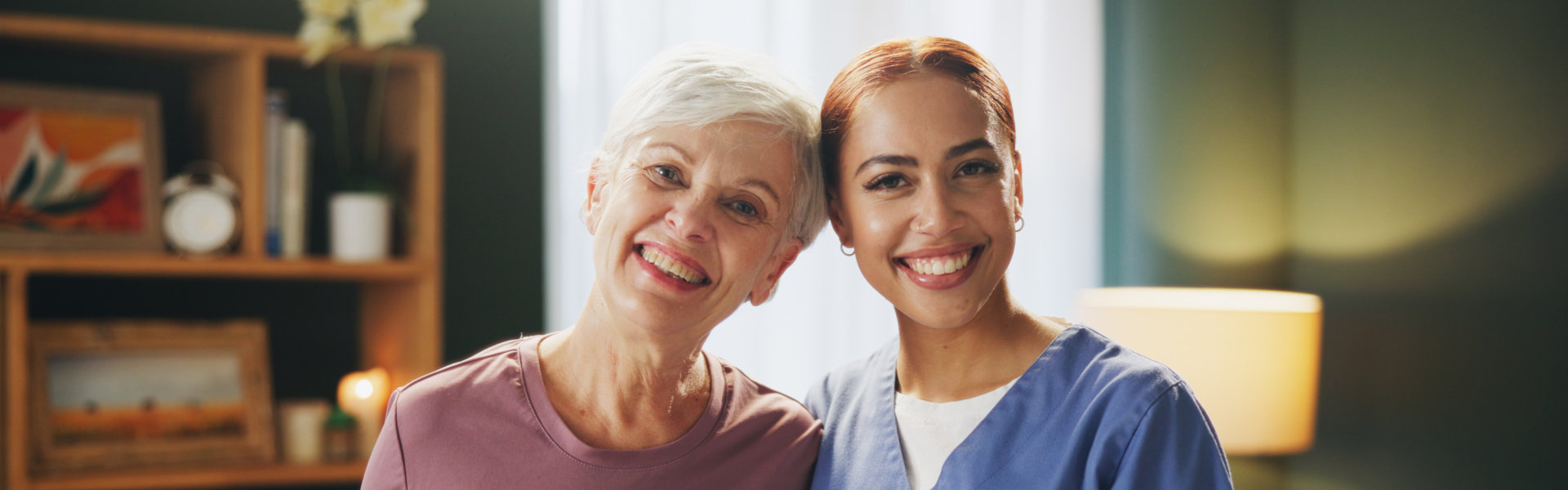 aide and senior woman smiling