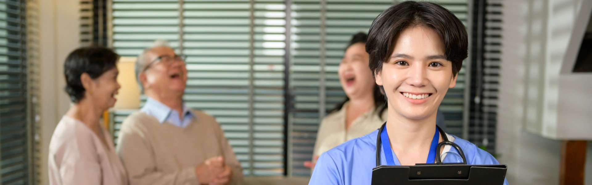 a woman smiling while an elderly on background